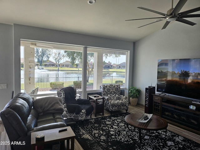 living room featuring ceiling fan and lofted ceiling