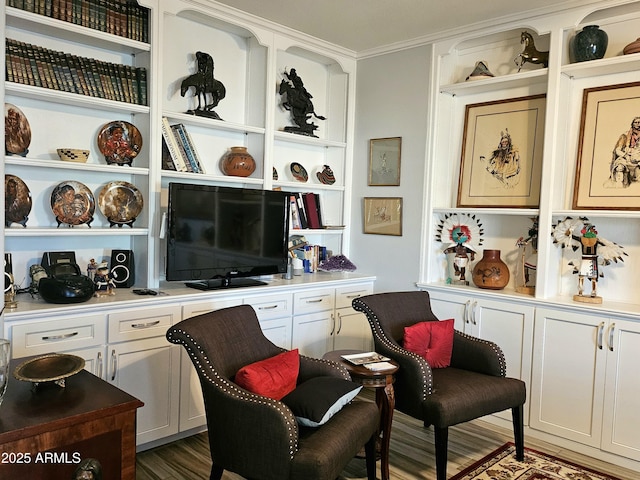 sitting room featuring dark hardwood / wood-style floors, built in desk, and ornamental molding