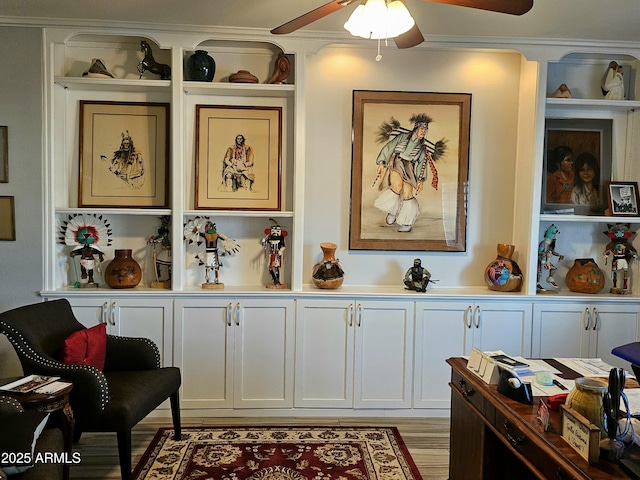 living area featuring ceiling fan, ornamental molding, and light hardwood / wood-style flooring