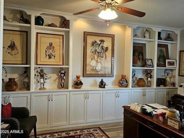 interior space featuring hardwood / wood-style flooring, ceiling fan, and crown molding