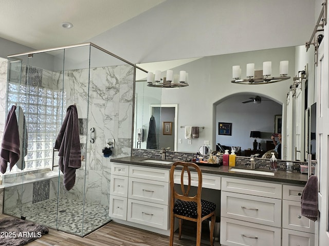 bathroom with a shower with door, vanity, and hardwood / wood-style floors