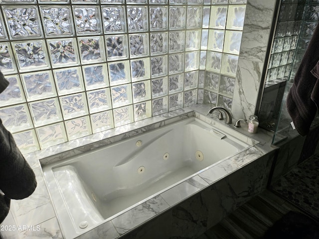 bathroom with a relaxing tiled tub