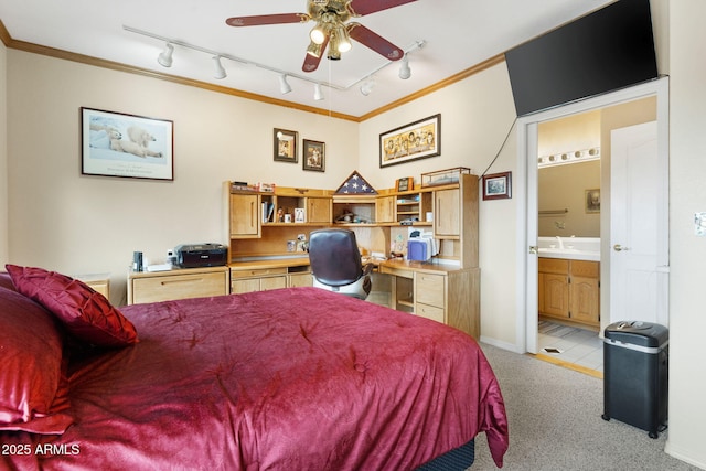 bedroom with connected bathroom, crown molding, baseboards, light carpet, and a sink