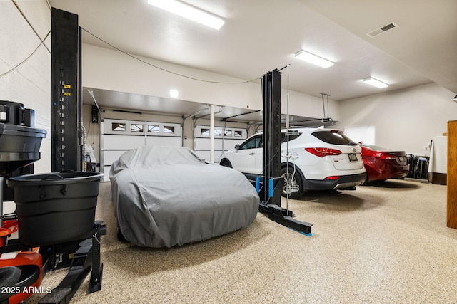 garage featuring concrete block wall and visible vents