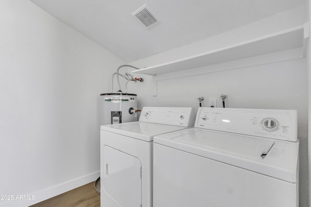 15435 N 28th St Unit 3, Phoenix, AZ 85032 - washroom featuring light wood finished floors, baseboards, washing machine and dryer, and electric water heater