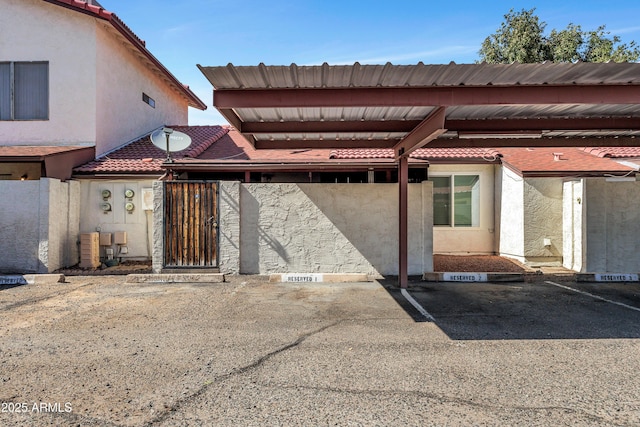 15435 N 28th St Unit 3, Phoenix, AZ 85032 - view of exterior entry featuring covered parking, a tile roof, and stucco siding