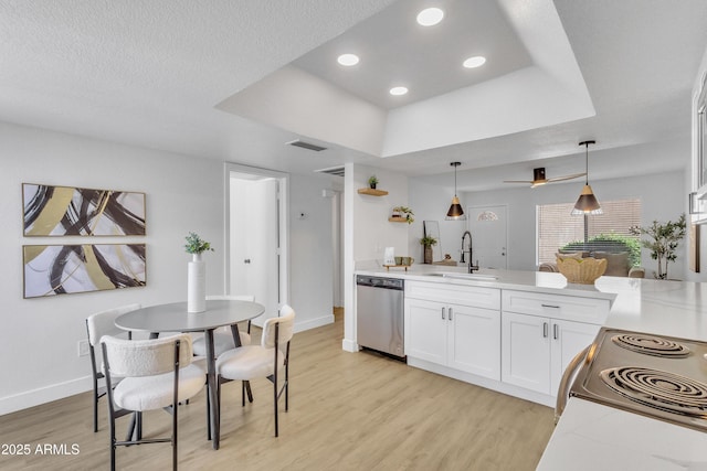 15435 N 28th St Unit 3, Phoenix, AZ 85032 - kitchen with appliances with stainless steel finishes, a sink, light wood-style flooring, a raised ceiling, and a peninsula