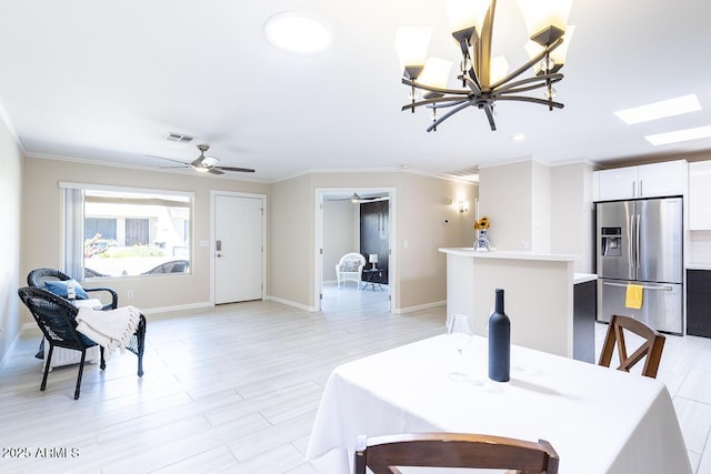 14300 W Bell Rd Unit 222, Surprise, AZ 85374 - dining area with ornamental molding, baseboards, light wood-style flooring, and ceiling fan with notable chandelier