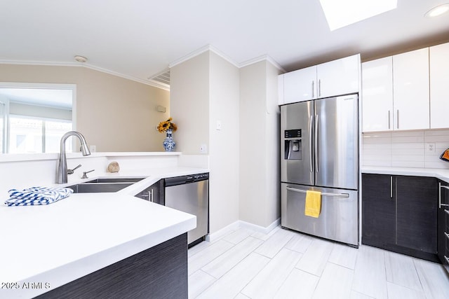 14300 W Bell Rd Unit 222, Surprise, AZ 85374 - kitchen featuring appliances with stainless steel finishes, light countertops, crown molding, and a sink