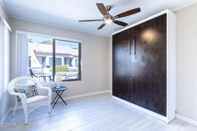 14300 W Bell Rd Unit 222, Surprise, AZ 85374 - sitting room with wood finished floors, ceiling fan, and ornamental molding