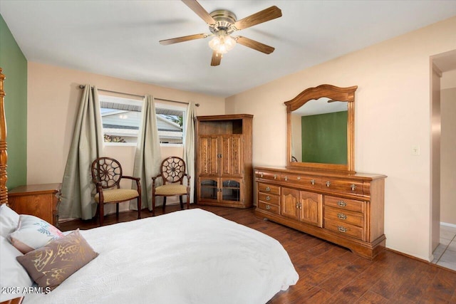 bedroom with ceiling fan and dark hardwood / wood-style flooring