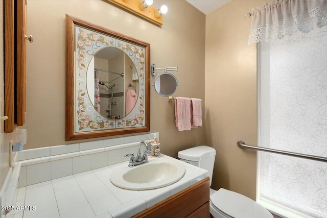 bathroom with toilet, walk in shower, and vanity