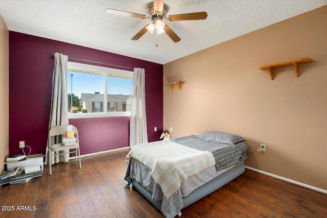 bedroom featuring ceiling fan, a textured ceiling, and dark hardwood / wood-style flooring