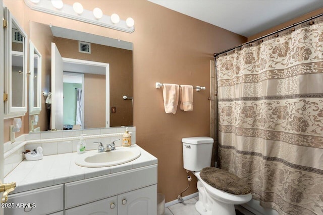 bathroom with curtained shower, toilet, vanity, and tile patterned flooring