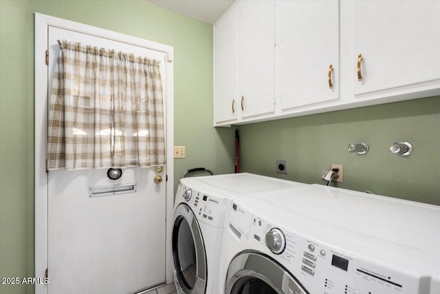 washroom with cabinets and washer and dryer