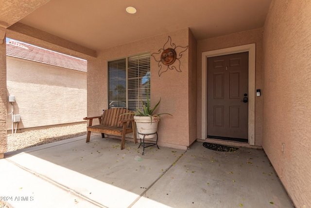 doorway to property featuring stucco siding