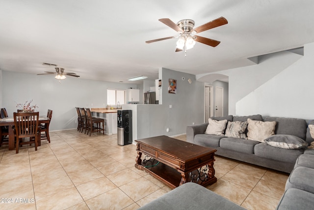 tiled living room featuring ceiling fan