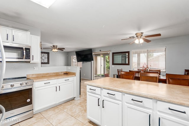 kitchen featuring ceiling fan, white cabinetry, range with electric cooktop, and light tile patterned floors