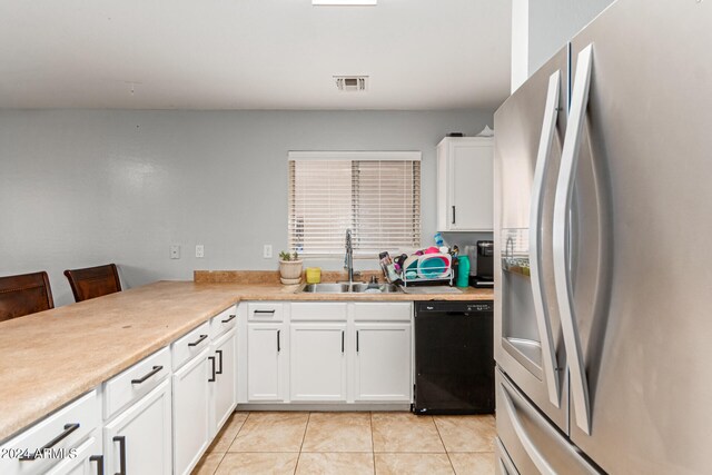 kitchen with black dishwasher, stainless steel fridge with ice dispenser, white cabinets, light tile patterned floors, and sink