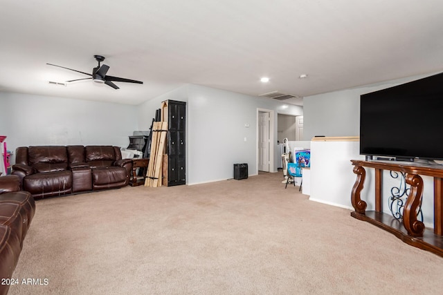 living room featuring carpet floors, visible vents, and a ceiling fan