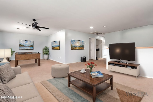 living area featuring light carpet, baseboards, visible vents, and a ceiling fan