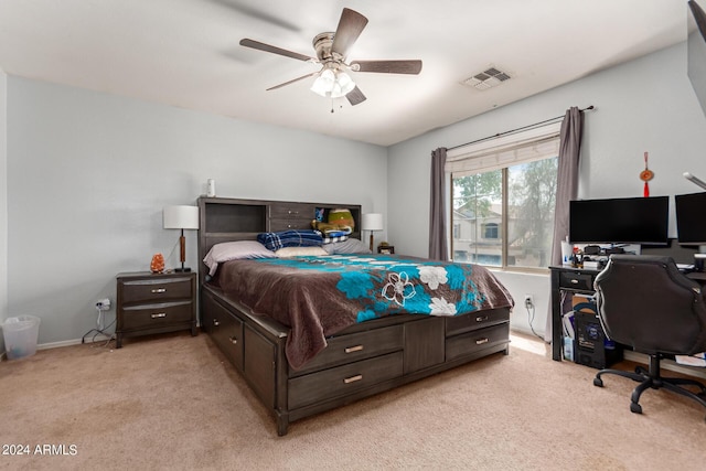 bedroom featuring ceiling fan, visible vents, and light colored carpet