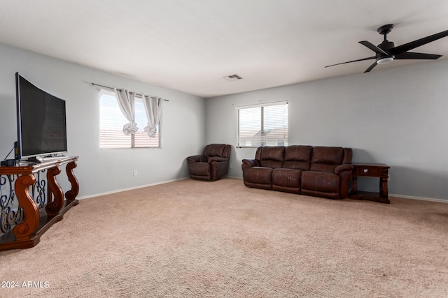 living room with ceiling fan and light colored carpet