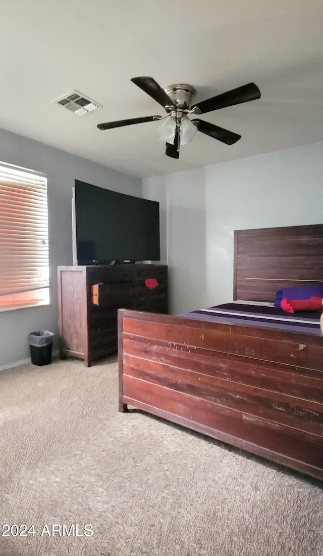 bedroom featuring a ceiling fan, carpet, and visible vents