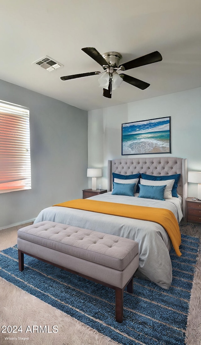 bedroom with carpet floors, visible vents, ceiling fan, and baseboards