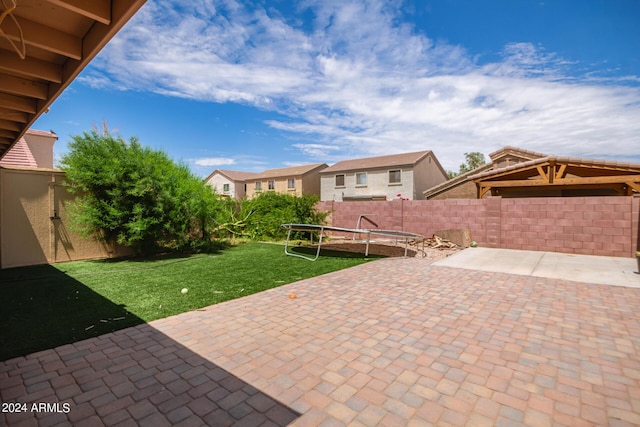 view of patio / terrace featuring a trampoline and a fenced backyard