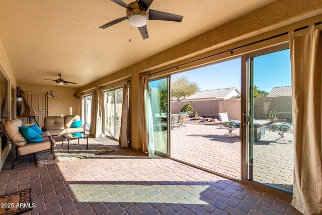 sunroom with ceiling fan