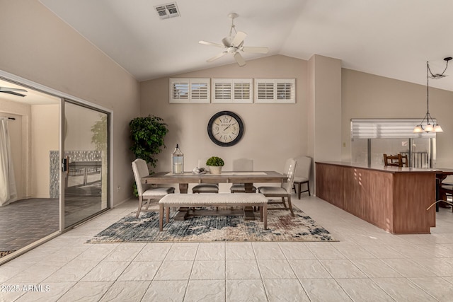 dining room with lofted ceiling, ceiling fan with notable chandelier, and light tile patterned floors