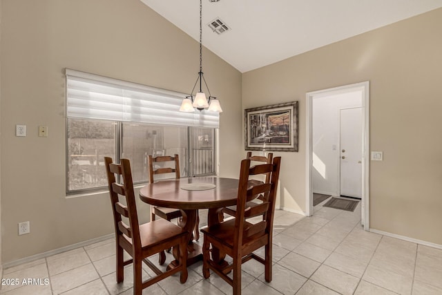 dining space featuring vaulted ceiling and light tile patterned floors