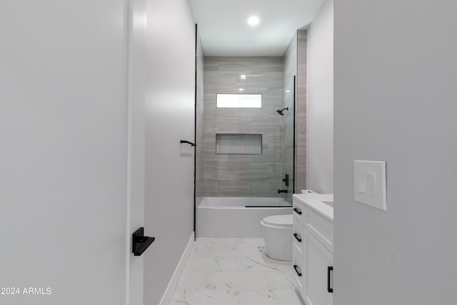 full bathroom featuring vanity, tiled shower / bath combo, and toilet