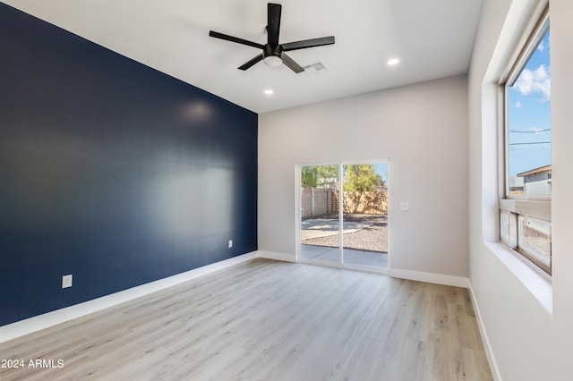 empty room featuring ceiling fan and light hardwood / wood-style flooring