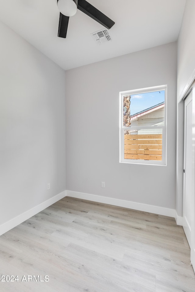 spare room featuring light hardwood / wood-style flooring and ceiling fan