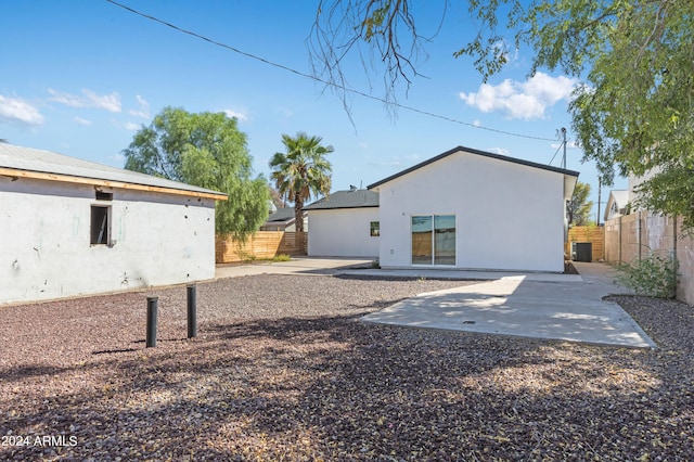 back of house with a patio and cooling unit