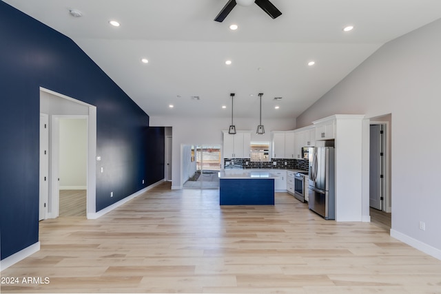 kitchen with a center island, white cabinetry, stainless steel appliances, decorative light fixtures, and ceiling fan