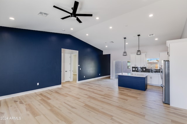 kitchen featuring pendant lighting, white cabinets, a kitchen island, ceiling fan, and stainless steel fridge