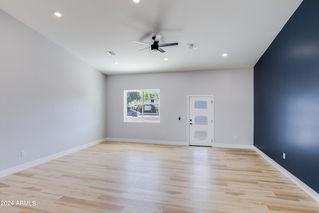 empty room with light hardwood / wood-style flooring and ceiling fan