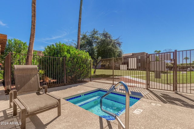 view of pool with a lawn and a community hot tub