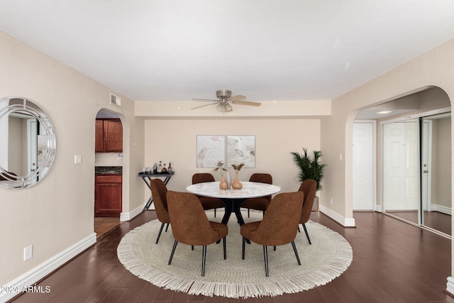 dining space with dark hardwood / wood-style floors and ceiling fan