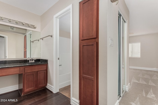 bathroom featuring vanity, hardwood / wood-style flooring, and walk in shower