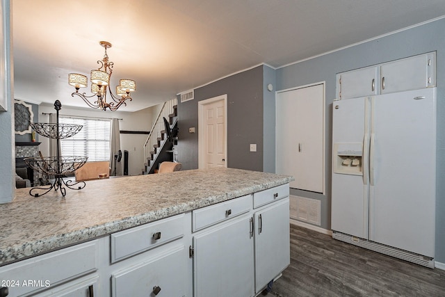 kitchen featuring white cabinets, hanging light fixtures, an inviting chandelier, dark hardwood / wood-style floors, and white refrigerator with ice dispenser