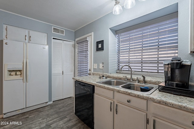 kitchen featuring sink, black dishwasher, white cabinetry, and white refrigerator with ice dispenser