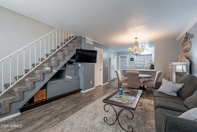 living room featuring ornamental molding, an inviting chandelier, and dark hardwood / wood-style floors