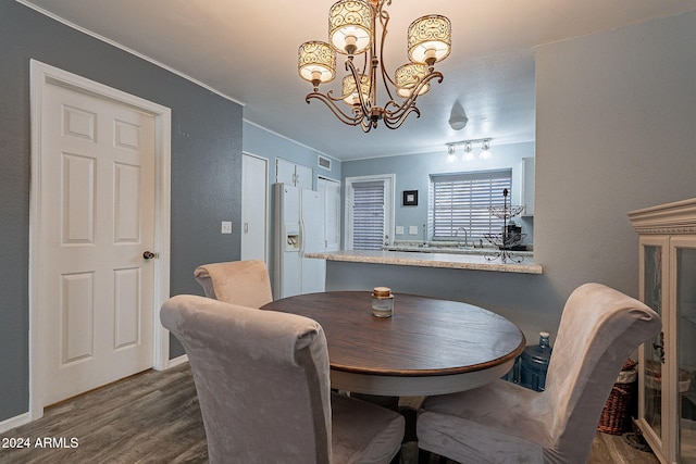 dining room with a chandelier and dark hardwood / wood-style floors