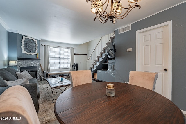 carpeted dining area with crown molding and a tile fireplace