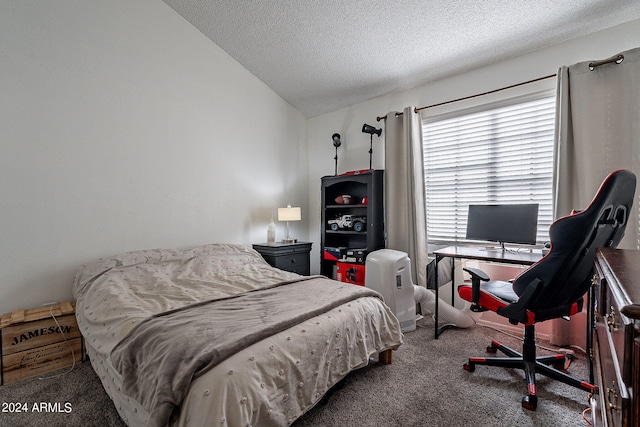 bedroom with lofted ceiling, a textured ceiling, and dark colored carpet