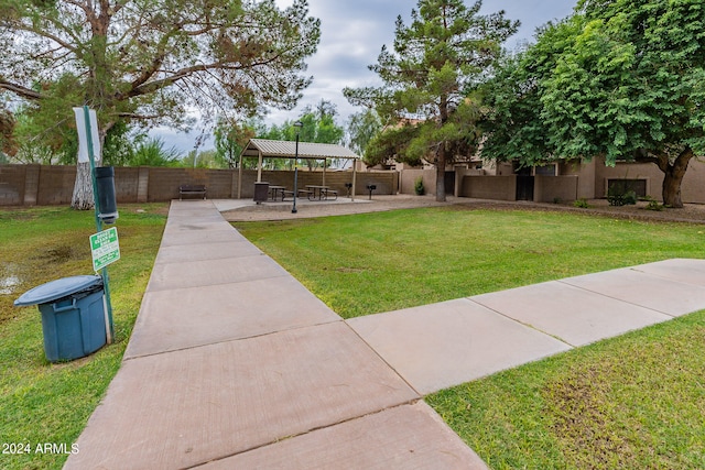 view of home's community featuring a patio, a gazebo, and a lawn